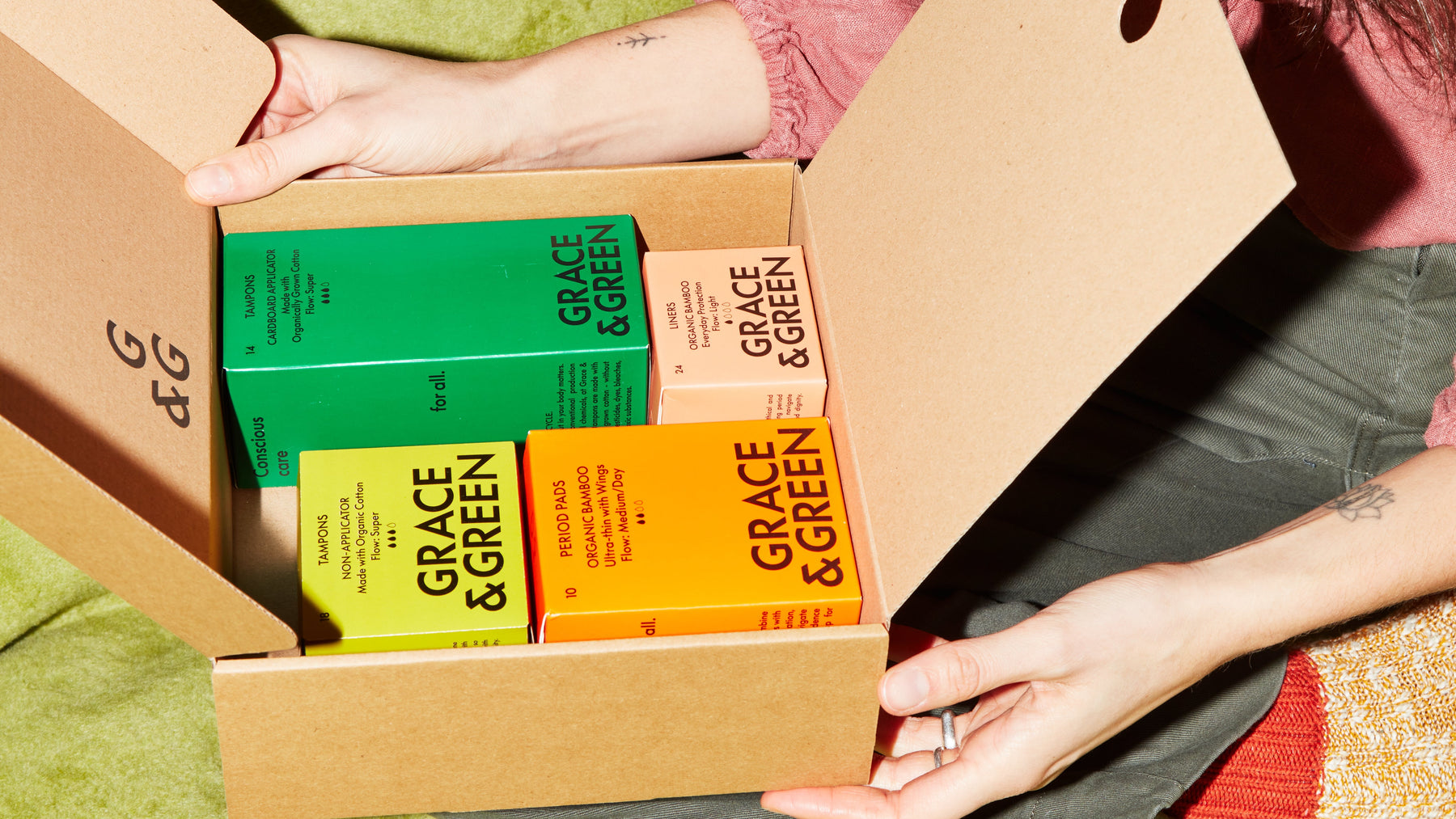 Grace & Green products inside a box, including tampons and period pads