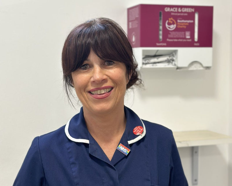 Nurse smiling with Grace & Green dispenser in the background.