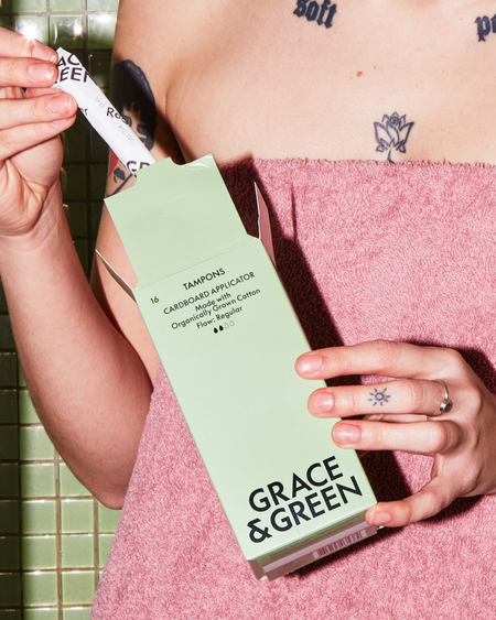 Grace & Green organic cotton tampons being taken from the box.