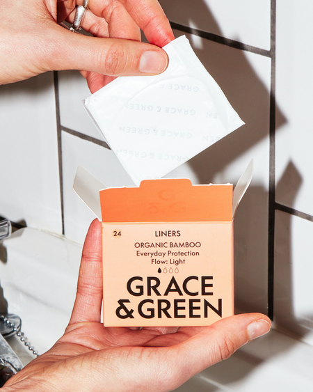 Grace & Green organic bamboo liners being taken from the box.